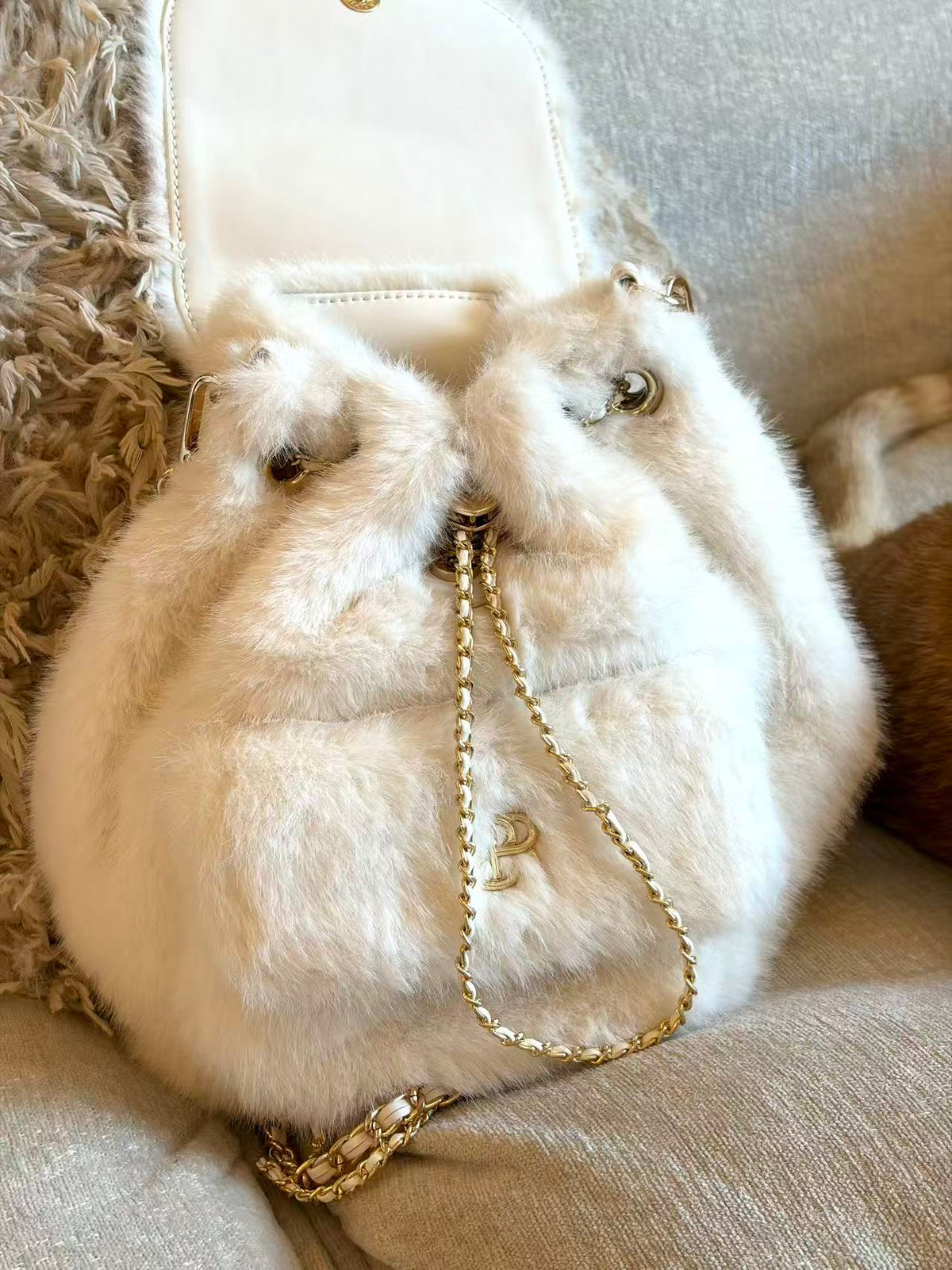 PSN Cream White Faux Fur Backpack – Gold Chain & Charm Detail